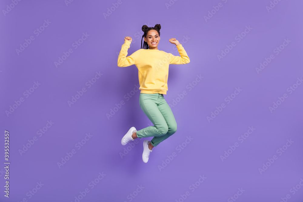 Full size photo of optimistic girl jump wear yellow shirt trousers sneakers isolated on lilac color background