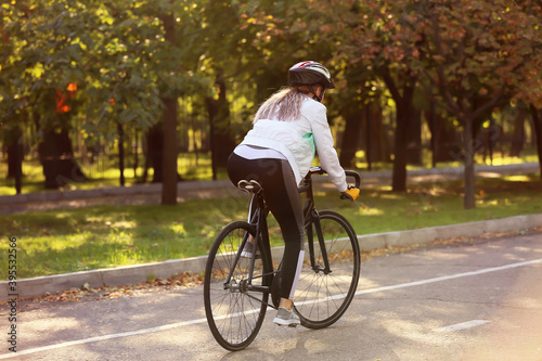 Female cyclist riding bicycle outdoors