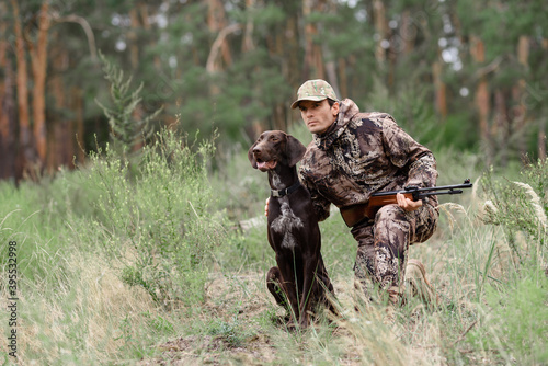 Obraz na płótnie Alert Hunter and Dog in Forest Animal Chasing.