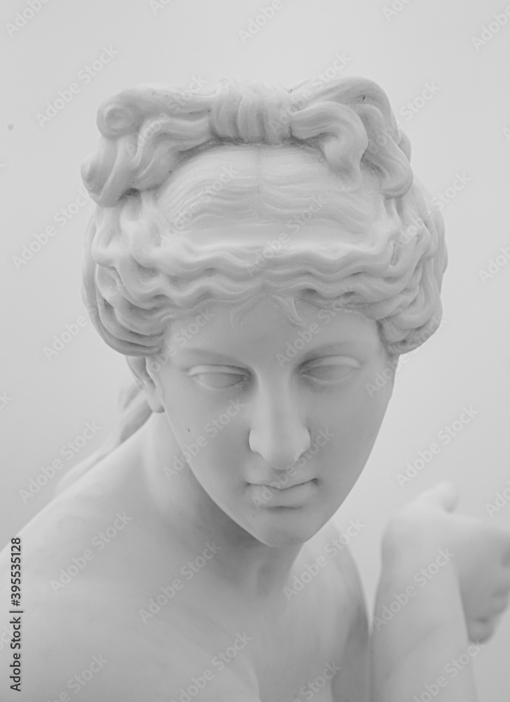 White marble sculpture head of young woman. Statue of sensual renaissance art era naked woman in circlet antique style on white background White marble sculpture head of young woman. Statue of sensual renaissance art era naked woman in circlet antique style on white background
