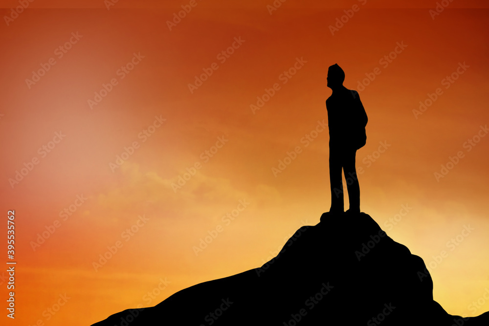 Silhouette of Businessman stand on the top of hill , achievement , success and leadership concept.