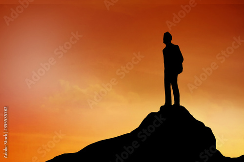 Silhouette of Businessman stand on the top of hill   achievement   success and leadership concept.