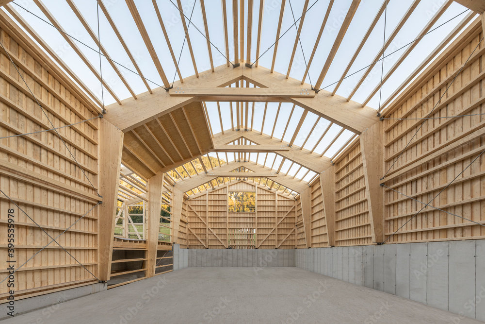 Large timber engineering hall under construction with laminated beams