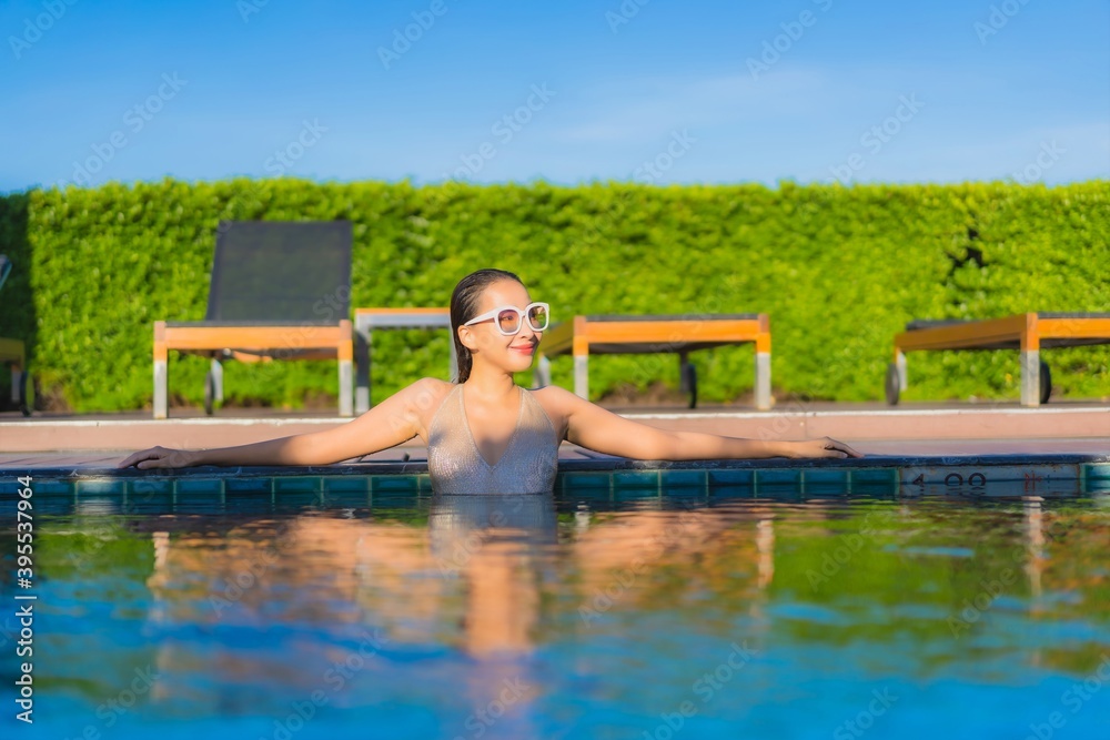 Portrait beautiful young asian woman relax smile leisure around outdoor swimming pool