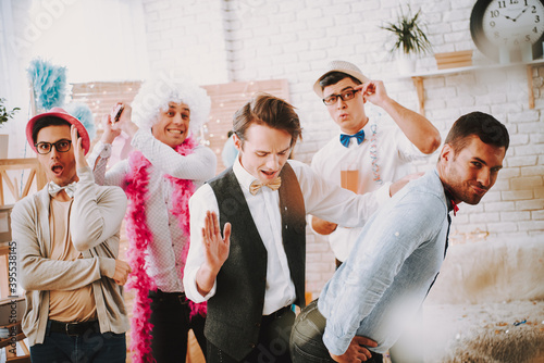 Photos Guys are having a party together and having fun.
