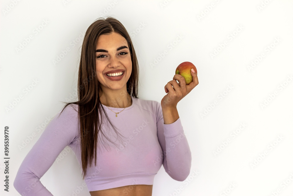 Photo of beautiful sporty woman with apple over white background.Close-up portrait of beautiful,fresh,healthy and sensual girl holding big delicious apple isolated on white.Health,beauty,diet concept. Photo of beautiful sporty woman with apple over white background.Close-up portrait of beautiful,fresh,healthy and sensual girl holding big delicious apple isolated on white.Health,beauty,diet concept.