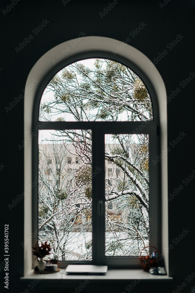 Arch window with snowy view outside. Christmas at home, 2021 new year