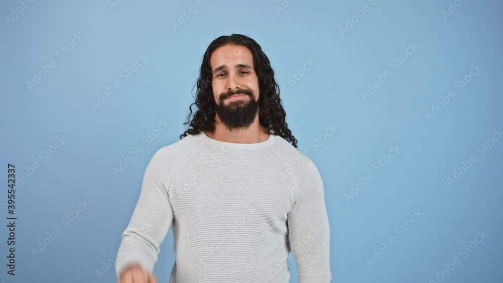 Studio portrait of sceptical bearded guy showing blah blah gesture, talking with his hand, expressing disbelief