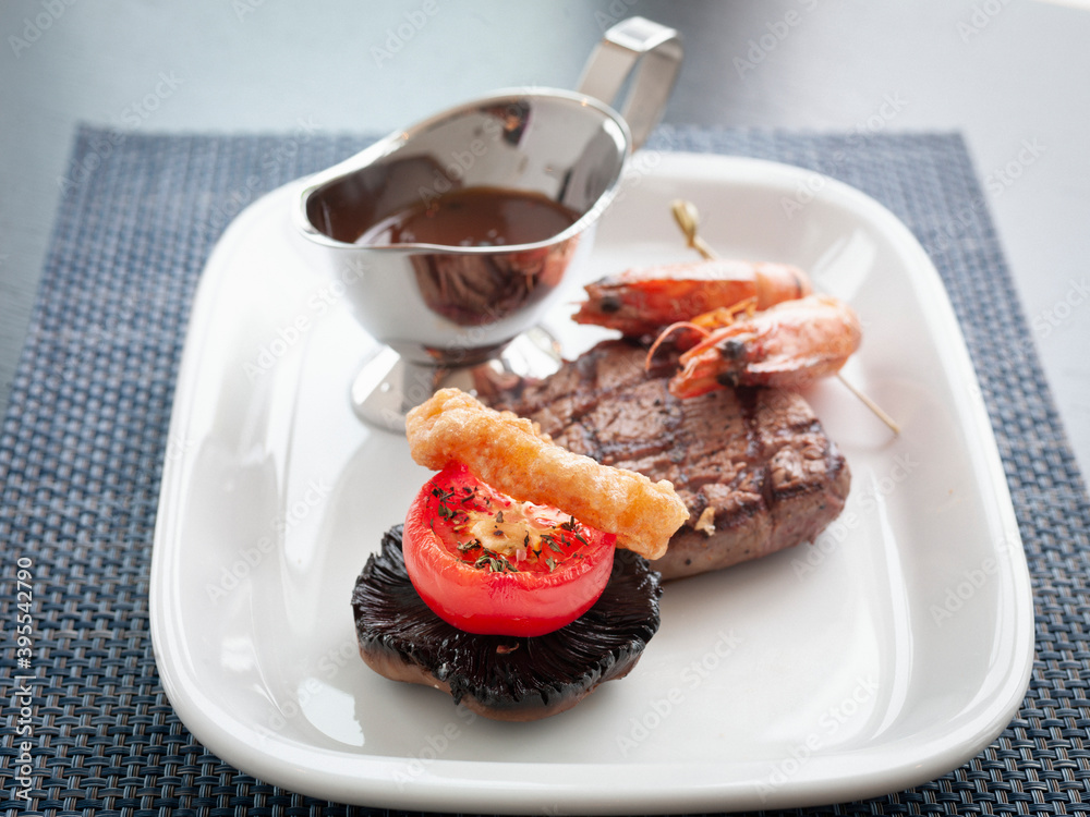 Surf and turf with portobello, grilled tomato and mozzarella stick Surf and turf with portobello, grilled tomato and mozzarella stick