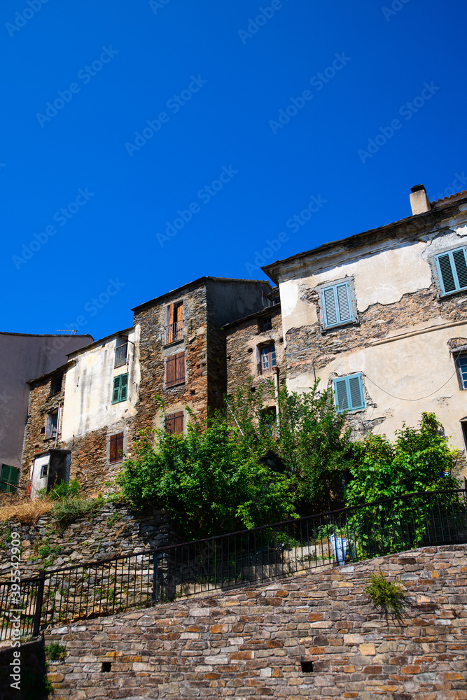 View on old houses in Corsican mountain village on a sunny day during summertime with a blue sky