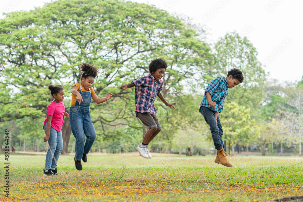 Happy African American childrens jumping over the rope in the park, Education outdoor concept Happy African American childrens jumping over the rope in the park, Education outdoor concept