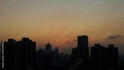 The sun sets behind the Shanghai skyline
