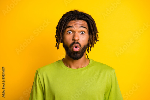 Portrait of impressed dark skin guy shout surprise isolated over vivid yellow color background © deagreez