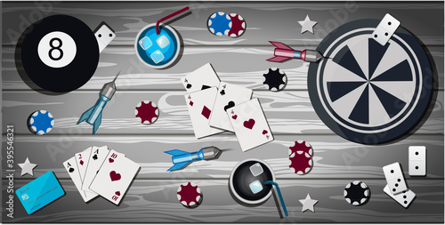 Top view of a wooden table with items for gambling and sports games. Table with items for playing Darts, bowling, cards, poker, dominoes, casino chips. The card for party with presents. Greeting card