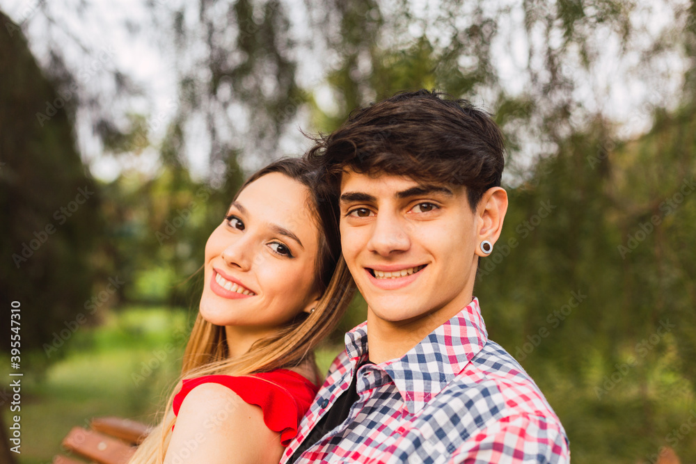 Portrait of a happy and smiling couple having fun together and enjoying their romantic date - Smiling couple in love outdoors. Portrait of a happy and smiling couple having fun together and enjoying their romantic date - Smiling couple in love outdoors.