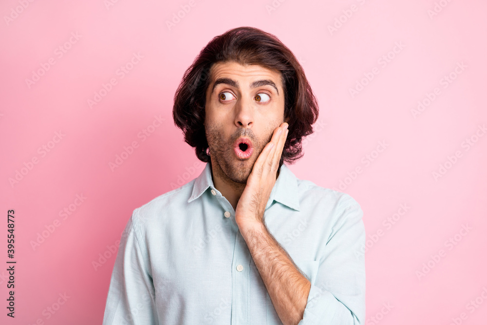 Close up photo of handsome person look empty space arm on cheek open mouth isolated on pastel pink color background Close up photo of handsome person look empty space arm on cheek open mouth isolated on pastel pink color background