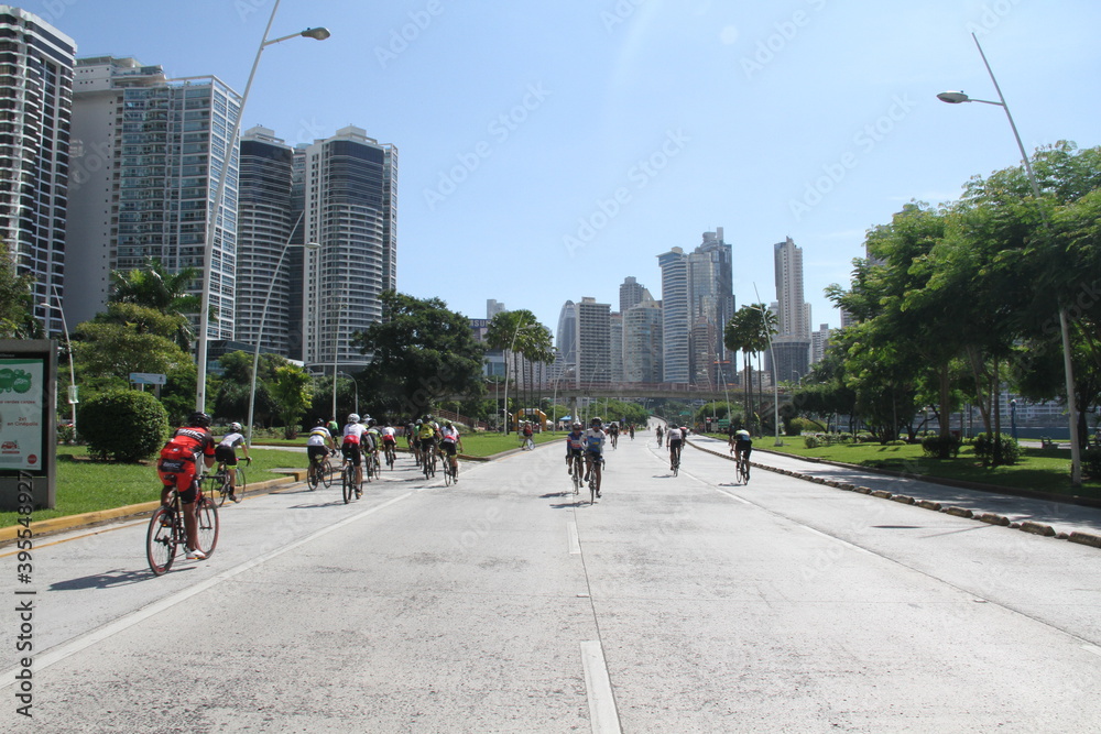 street with cyclists and buildings in the background on a sunny day