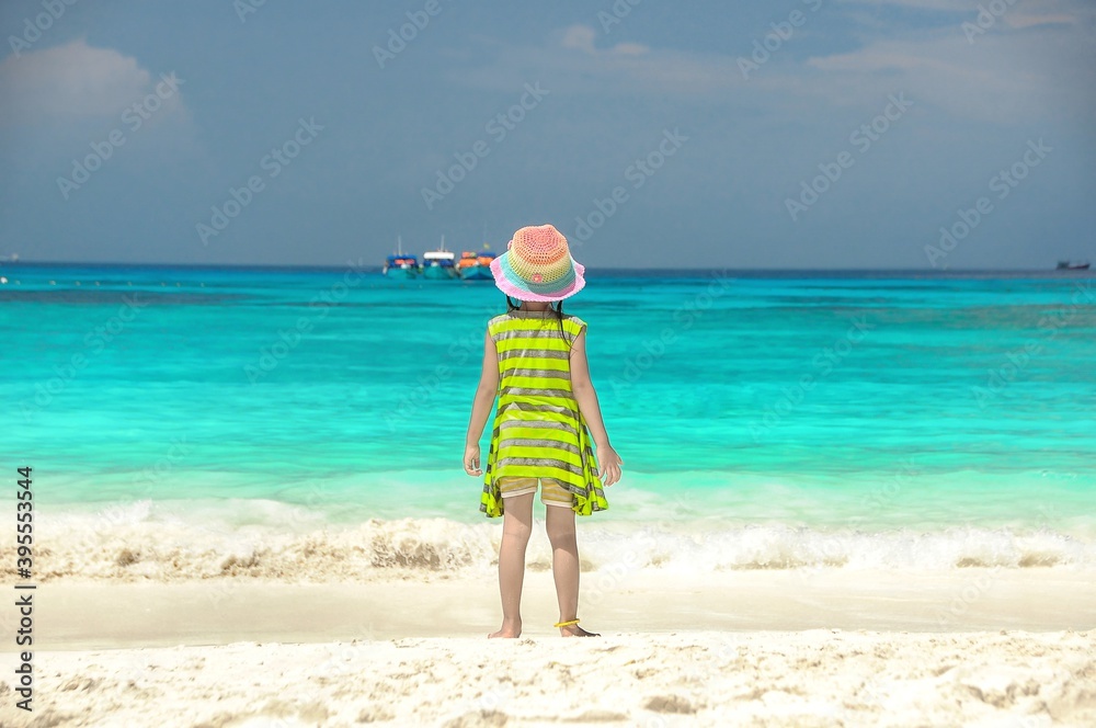 Girl is running in the blue sea. Blue sea.Summer sea travel.Summer beach travel. 