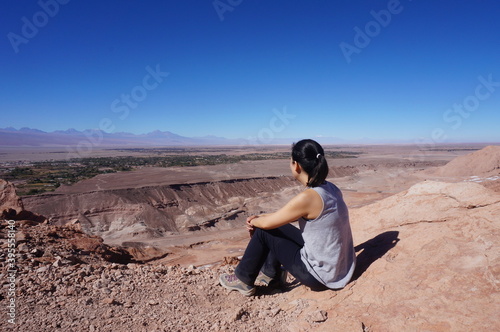 person sitting on a rock atacama