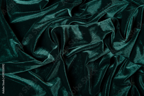 Tidewater green color velvet fabric background. Close up of green textured background.
