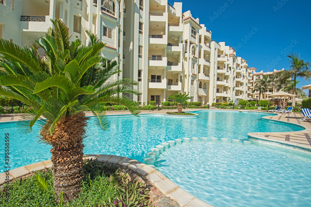 Fototapeta premium Swimming pool and gardens in a luxury tropical hotel resort