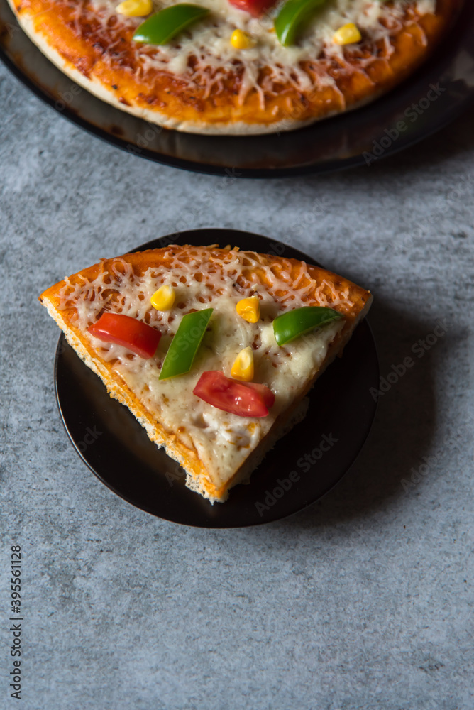 Top view of a slice of pizza on a plate with use of selective focus. Top view of a slice of pizza on a plate with use of selective focus.
