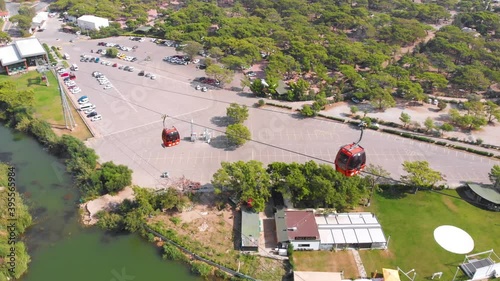 A close flight next to a funicular ascending the mountain against the backdrop of the Mediterranean coastline. An exciting climb in Turkey. High quality 4k footage