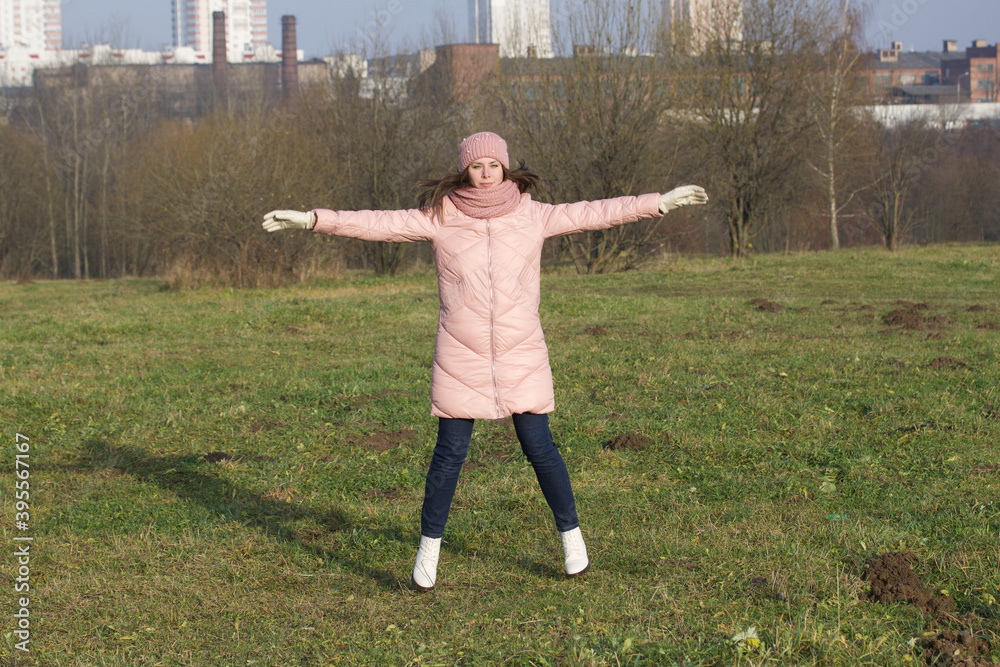 Girl in autumn clothes. Does gymnastics outdoors in the park. Girl in autumn clothes. Does gymnastics outdoors in the park.