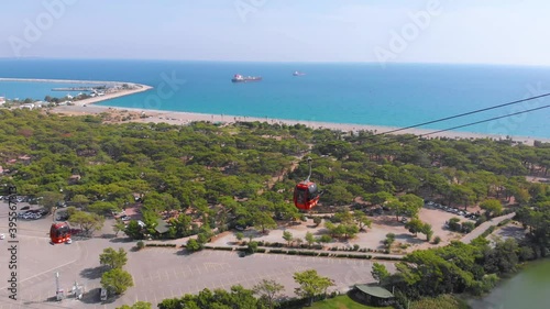 A close flight next to a funicular ascending the mountain against the backdrop of the Mediterranean coastline. An exciting climb in Turkey. High quality 4k footage