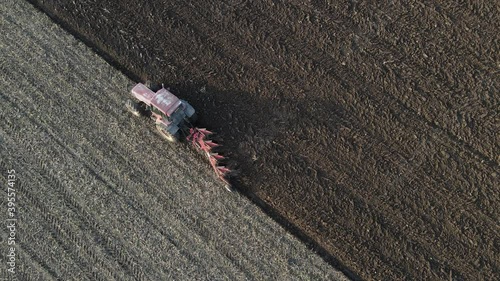 Birds eye view of tractor ploughing dry fields ready for planting, Overhead aerial View. photo