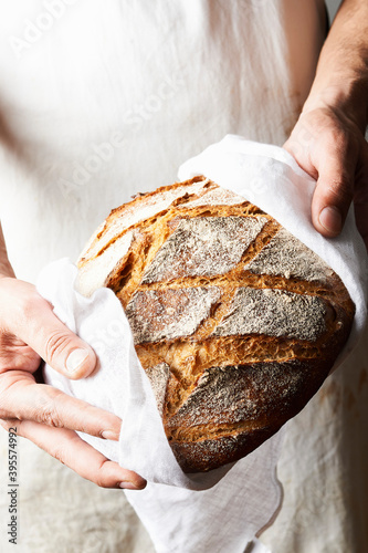 Baker holds freshly baked bread