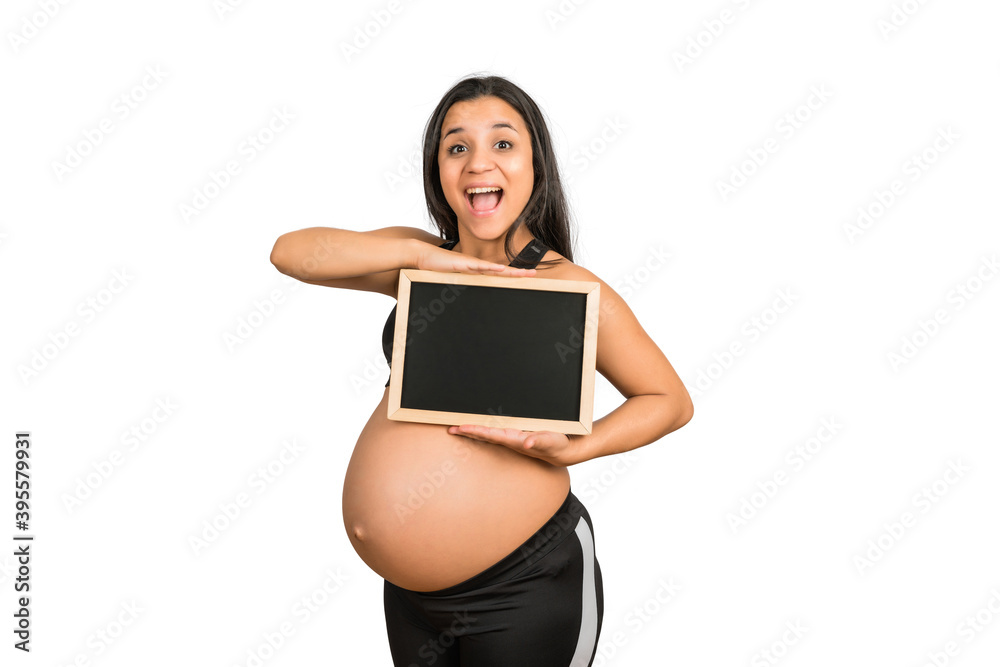 Pregnant woman showing something on chalkboard. Pregnant woman showing something on chalkboard.