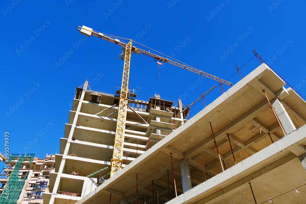 Construction site. High-rise multi-storey buildings under construction. Tower cranes near buildings. Construction site. High-rise multi-storey buildings under construction. Tower cranes near buildings.