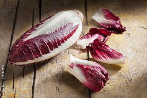 Long red chicory on rustic wooden table photo