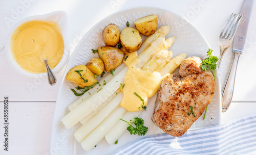 Pork steak with white asparagus and sauce Hollandaise photo