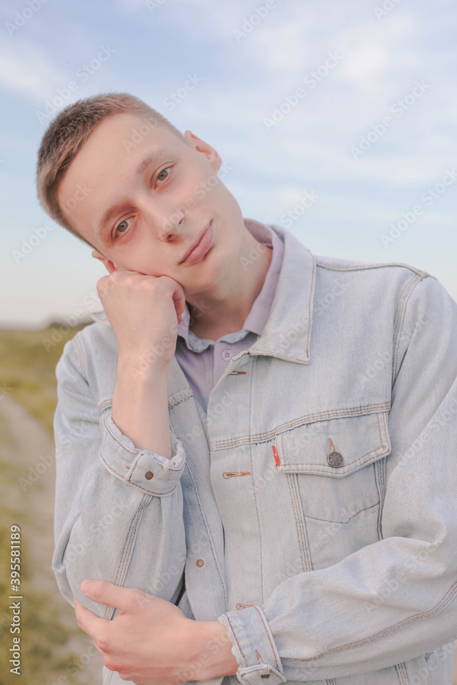 portrait, young, handsome, person, happy, guy, casual, smile, people, outdoors, sky, beach, white, smiling, looking, one, face, shirt, blue, standing, men, boy, summer, nature, sea