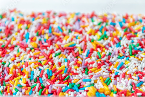 Many colorful sprinkles as delicious decoration or birthday cake topping with sweet candy sprinkles for sweet tooth and unhealthy snack for children as yummy confection for donuts and rainbow cakes