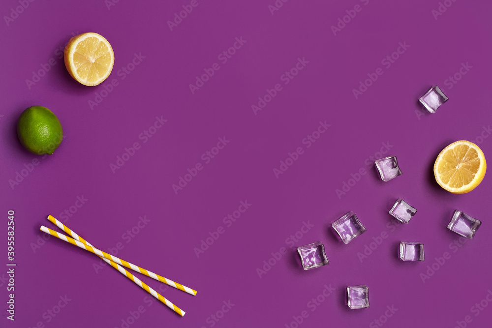Whole green lime, two halves of lemon, ice cubes and yellow tubules on purple studio background. Close up, copy space Whole green lime, two halves of lemon, ice cubes and yellow tubules on purple studio background. Close up, copy space