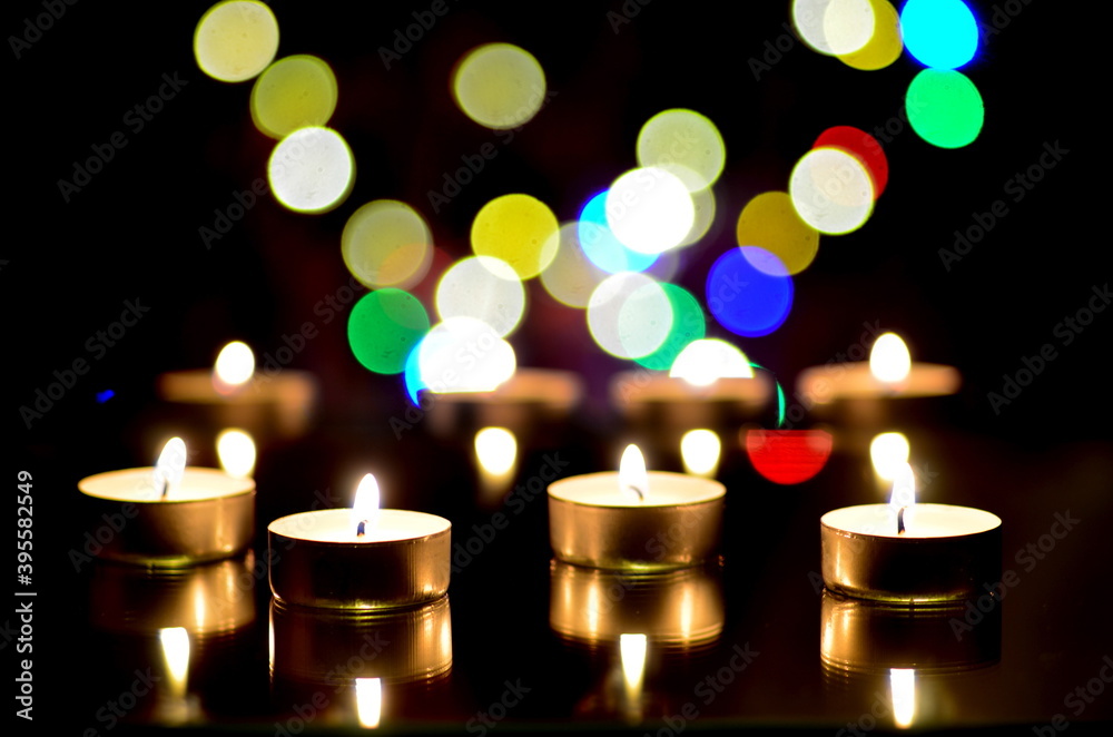 Many burning candles in the dark with bokeh effect Many burning candles in the dark with bokeh effect