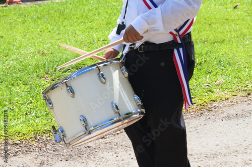 person in uniform playing drum, parade photo