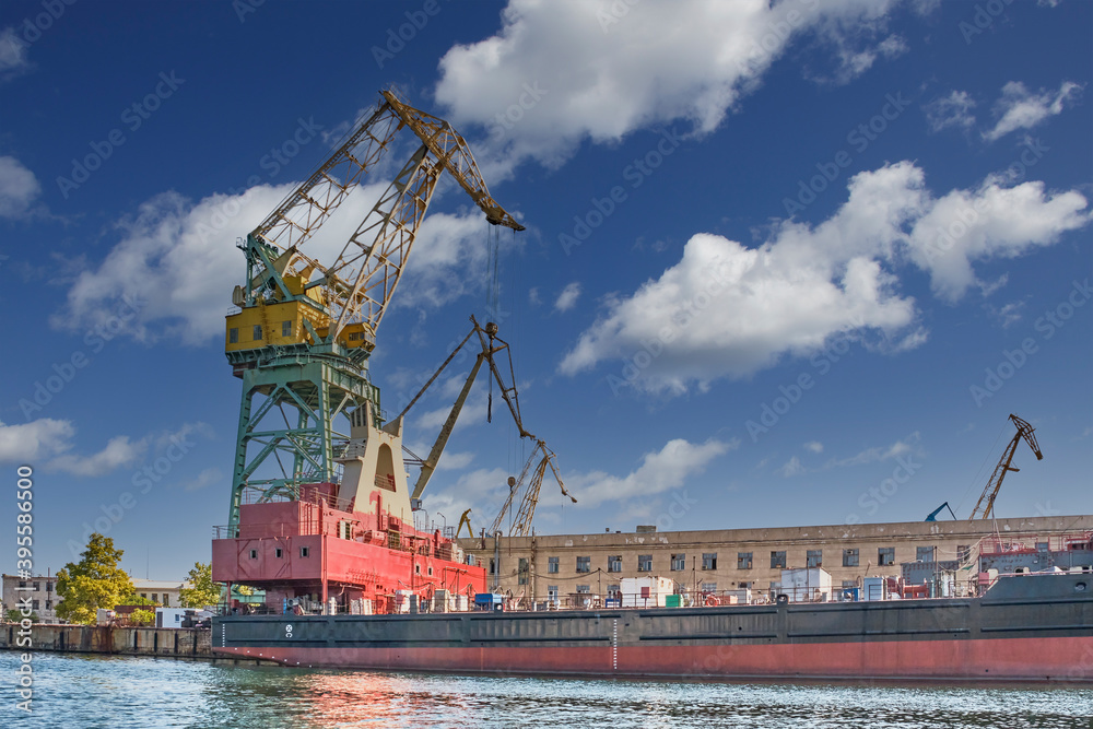 Crane on the background of buildings of the Sevastopol Marine Plant named after Sergo Ordzhonikidze Crane on the background of buildings of the Sevastopol Marine Plant named after Sergo Ordzhonikidze