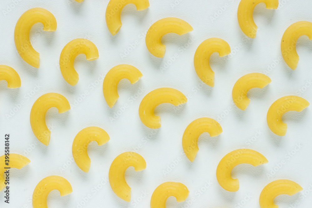 Close up of maccaroni noodles in symmetrical order on white background; isolated Close up of maccaroni noodles in symmetrical order on white background; isolated