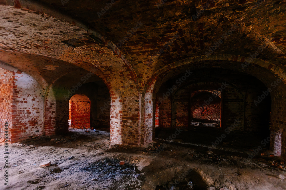 Fototapeta premium Dark and creepy vaulted red brick dungeon