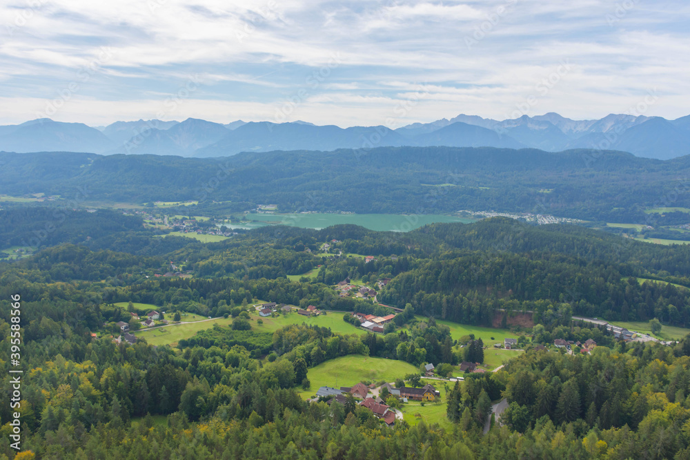 Charming village surrounded by mountains, view from The Pyramidenkogel, the highest wooden viewing tower in the world, famous tourists attraction at the lake Worthersee, Carinthia region, Austria