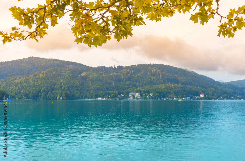 View of the alpine Lake Worthersee, famous tourist attraction for swimming, boating, sunbathing and walking, in Carinthia region, Austria
