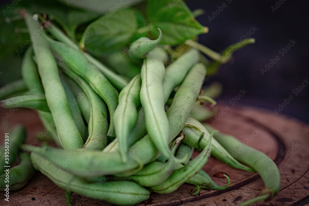 Green runner beans on a wooden plate Green runner beans on a wooden plate