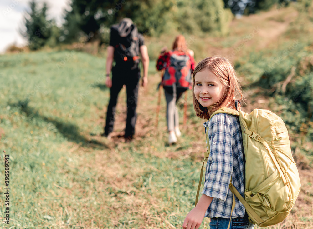 Smiling little girl trekking in mountains Smiling little girl trekking in mountains