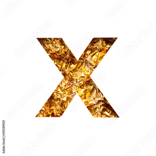 Letter X of English alphabet of golden crumpled foil and paper cut isolated on white. Festive golden typeface
