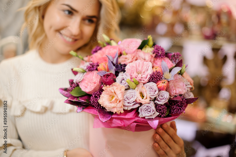 close-up of bouquet of multi-colored flowers in decorative round box in the hands of woman close-up of bouquet of multi-colored flowers in decorative round box in the hands of woman