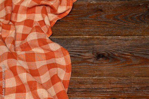 Checkered linen tablecloth on a wooden background